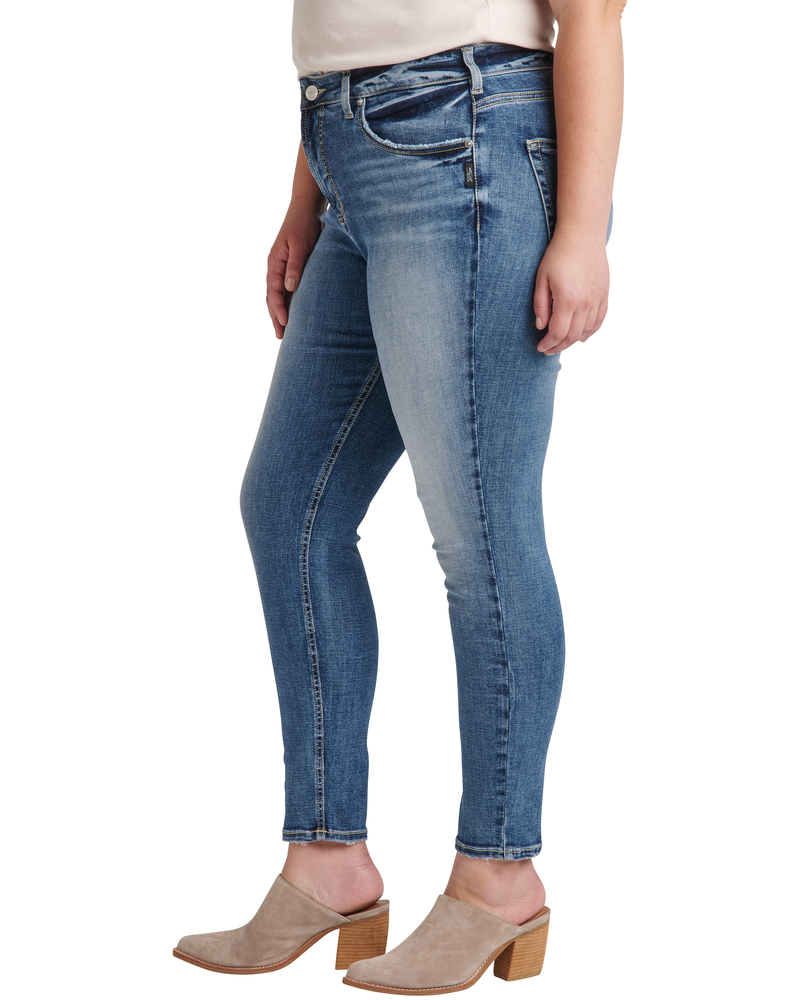 plus size woman in medium wash jeans and beige booties