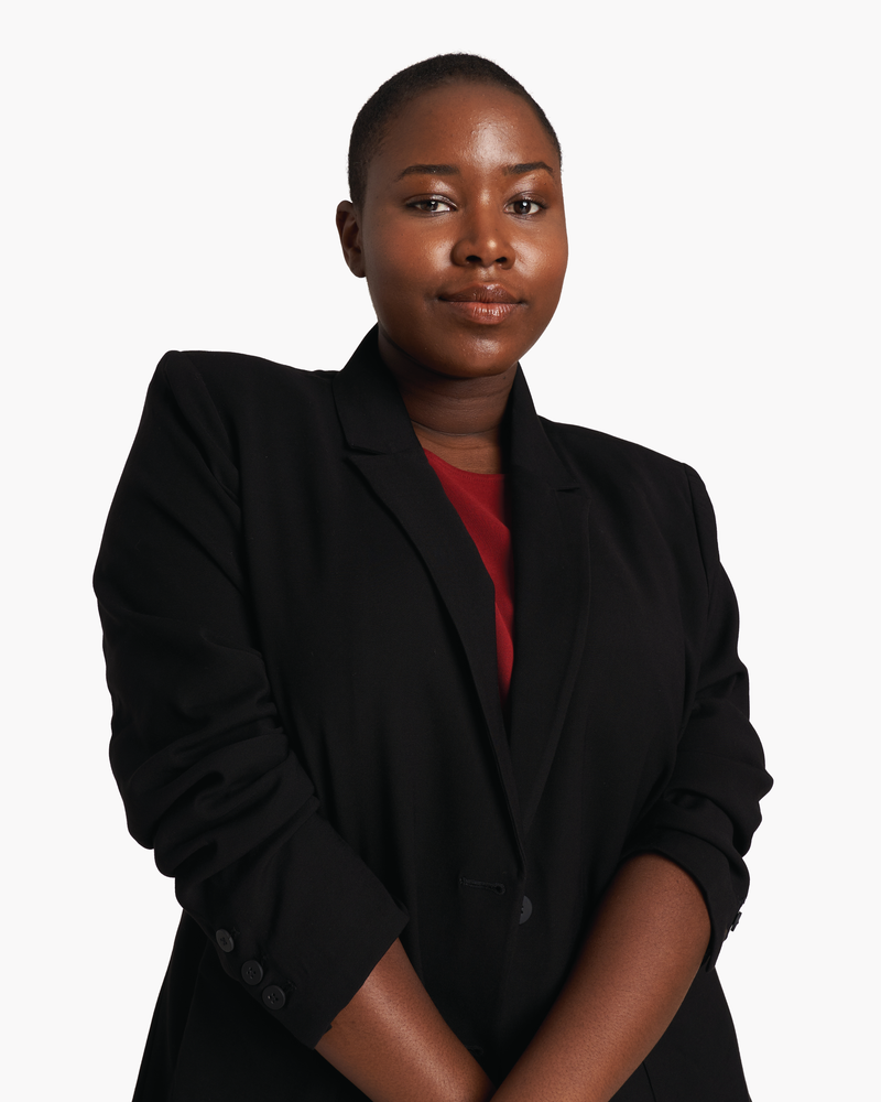 plus size woman in black blazer and red blouse
